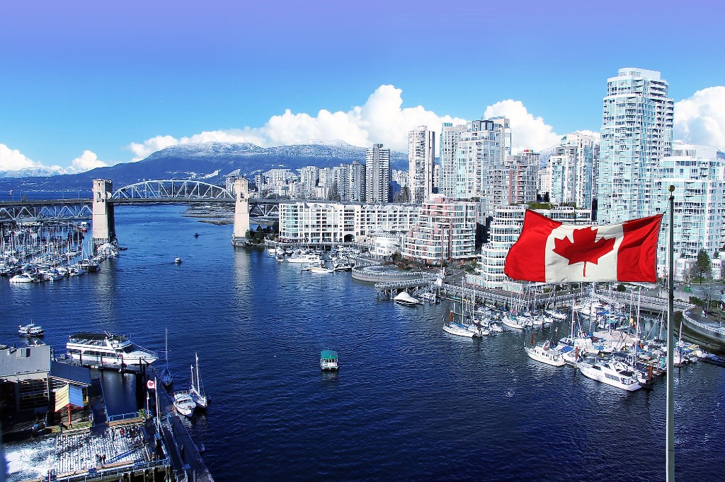 Vancouver harbour with the Canadian flag and city skyline